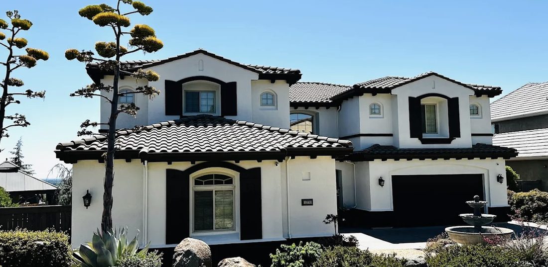 White home with dark trim after exterior painting